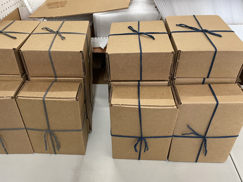 Customized gift wrapped boxes sitting on a store shelf ready for delivery.