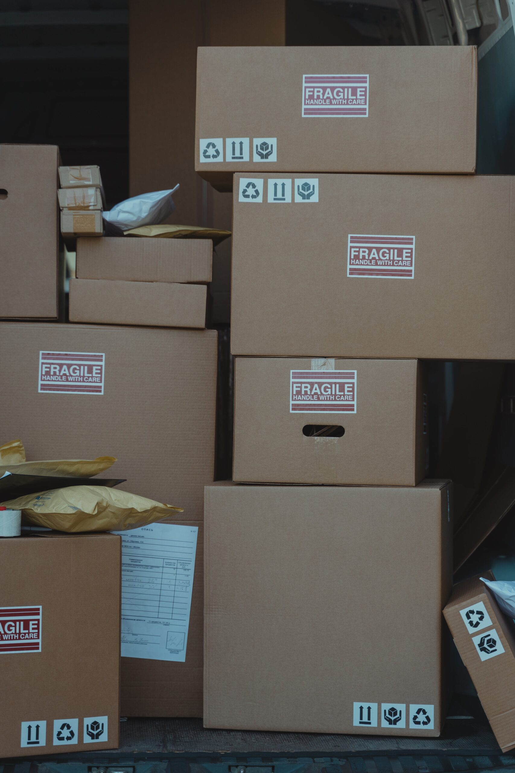 Close-up of stacked cardboard shipping boxes labeled fragile ready for delivery.